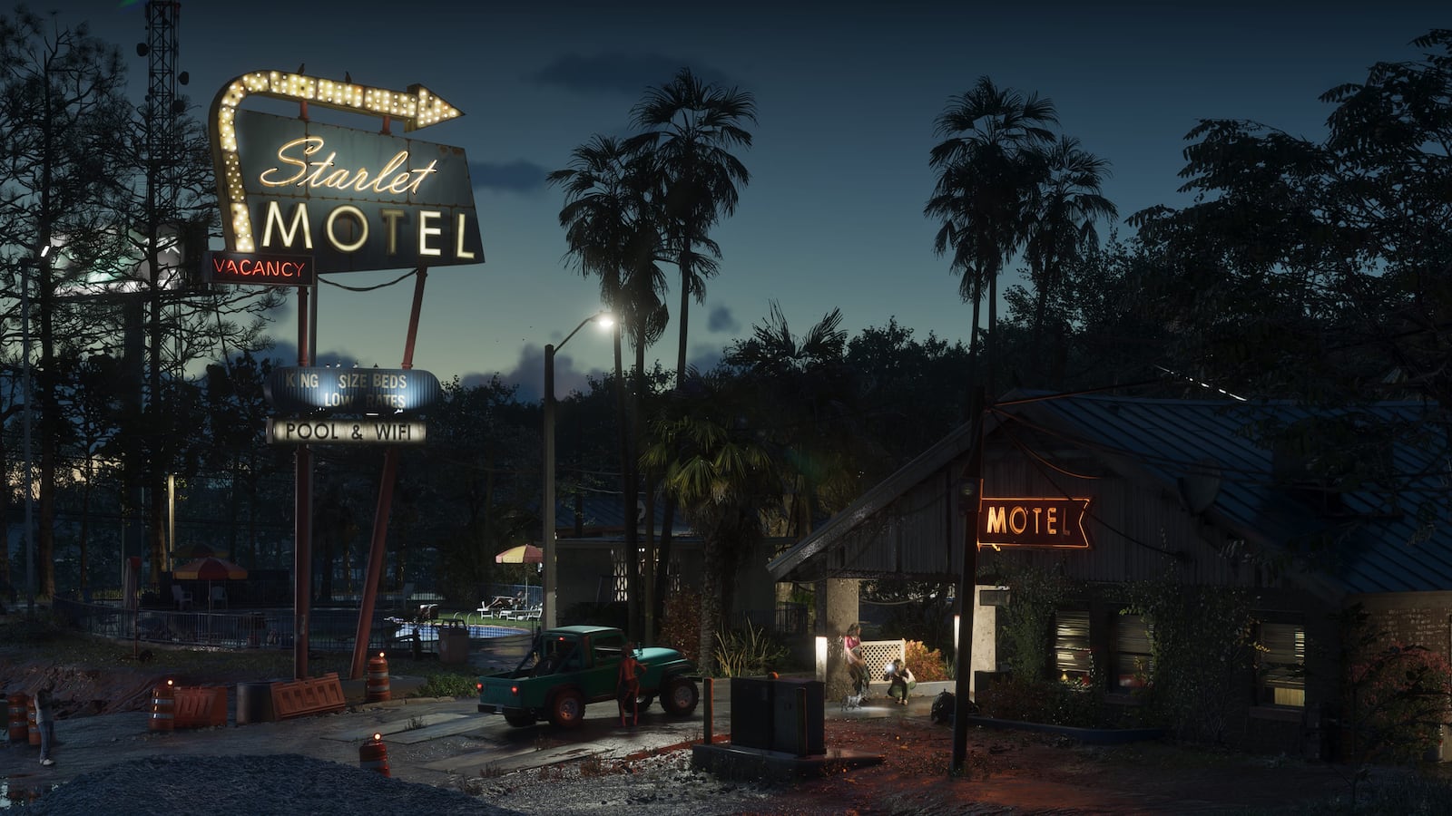 The Starlet Motel at night with neon signs and palm trees