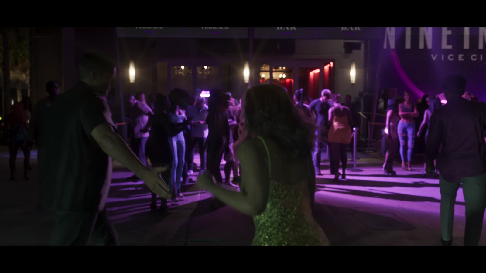 A crowded outdoor venue with a NINE Vice City sign in GTA VI Trailer 2